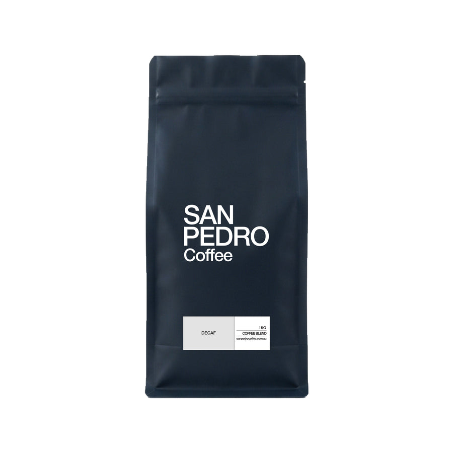 A dark navy blue stand-up coffee bag with white text reading 'SAN PEDRO Coffee' and a small white label near the bottom that says 'DECAF' and '100% COFFEE BLEND'.