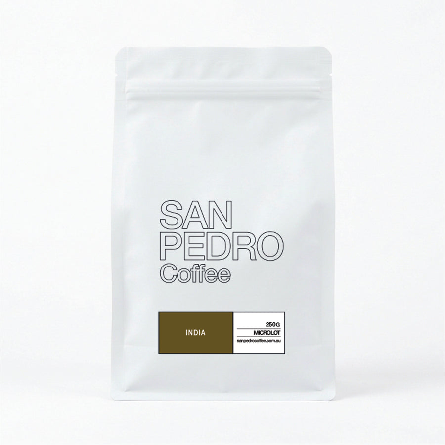 A white stand-up coffee bag with the text 'SAN PEDRO Coffee' in outlined gray lettering and a dark blue label at the bottom that reads 'UGANDA'.
