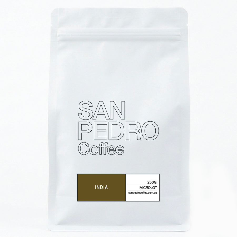 A white stand-up pouch of San Pedro Coffee, India, with a brown and white label at the bottom, photographed against a seamless white background.
