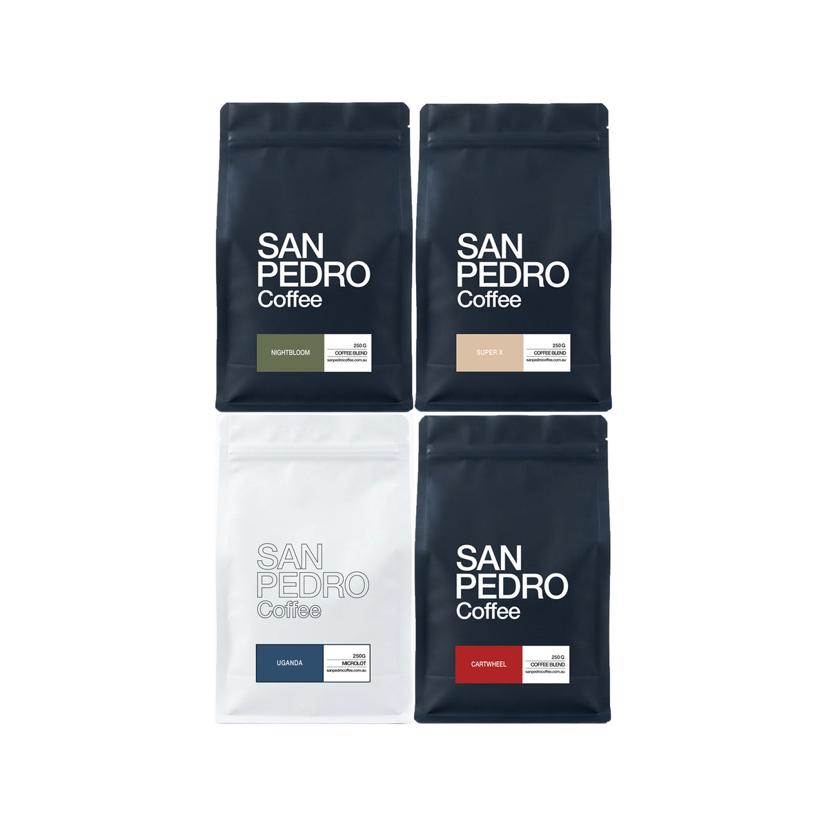 Four San Pedro Coffee stand-up pouches arranged in a 2x2 grid on a white background. The top two are dark navy with white text and small green/beige label blocks, and the bottom two are white and navy with blue/red label blocks.